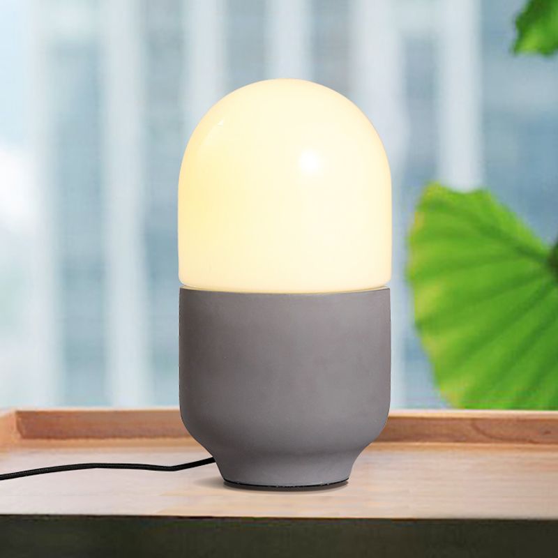 Zementkapselform kleiner Schreibtisch leichte minimalistische LED -Nachttischlampe in Grau mit weißem Glasschatten