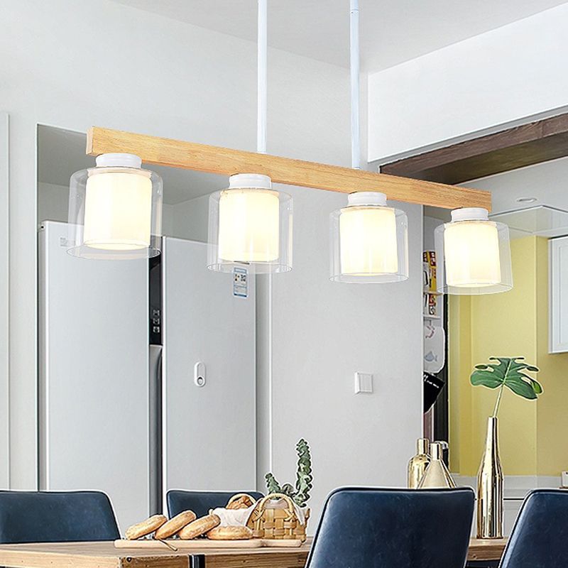 Ciondolo a isola moderna nordica con lampada da pranzo cilindrica in vetro del paralume.