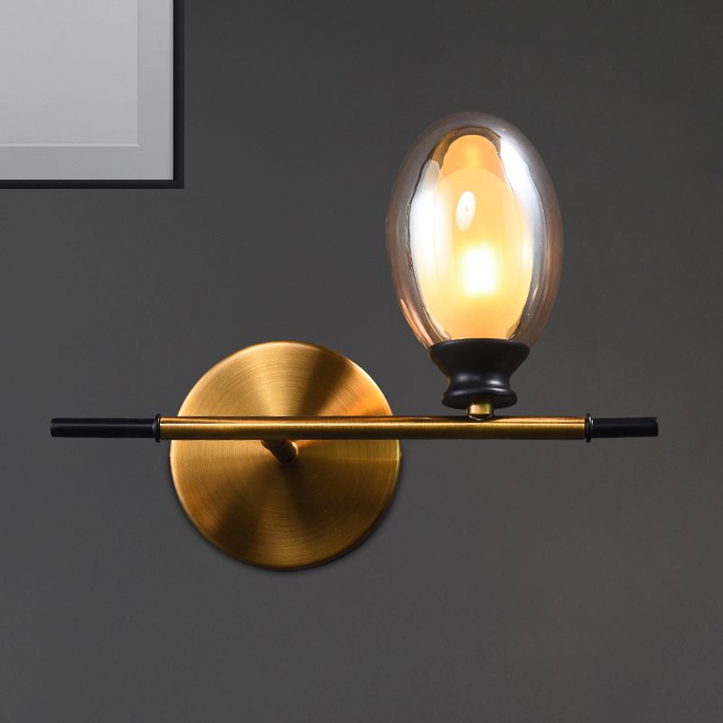 Clear/Amber Glass Egg Shape Wall Light Fixture Minimalist 1 Light Brass Sconce with Horizontal Arm