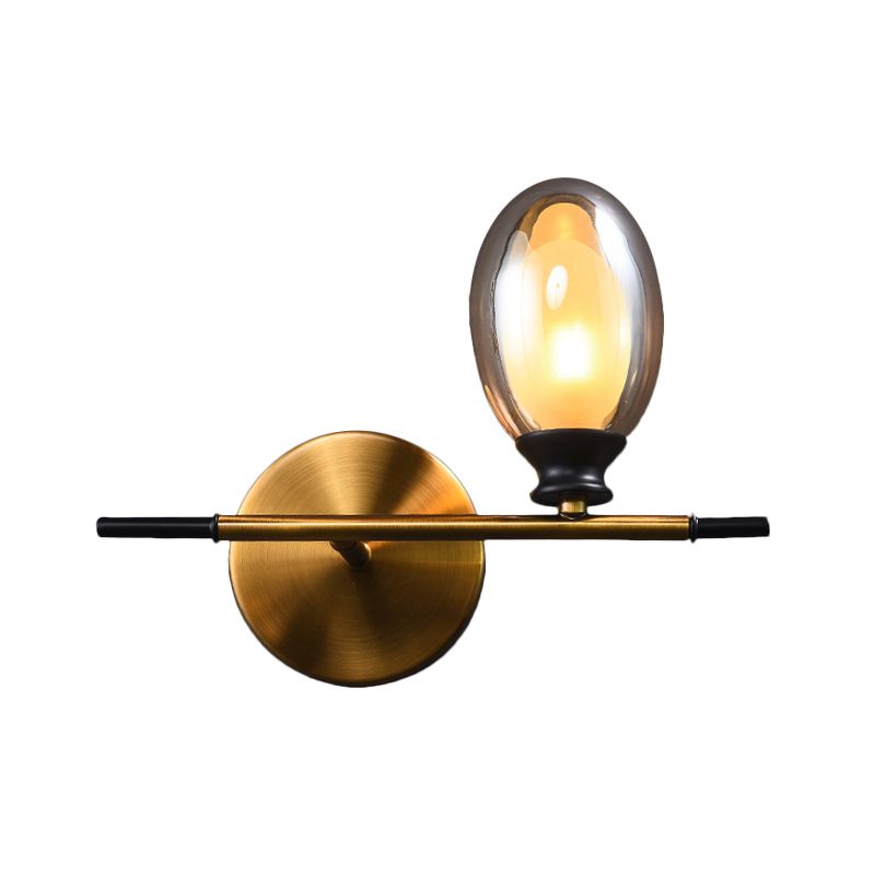 Clear/Amber Glass Egg Shape Wall Light Fixture Minimalist 1 Light Brass Sconce with Horizontal Arm