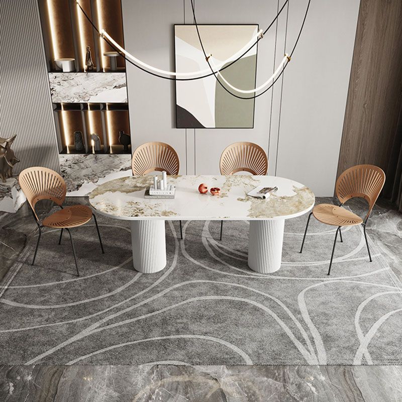 Table de salle à manger ovale moderne avec dessus en pierre et double piédestal en métal
