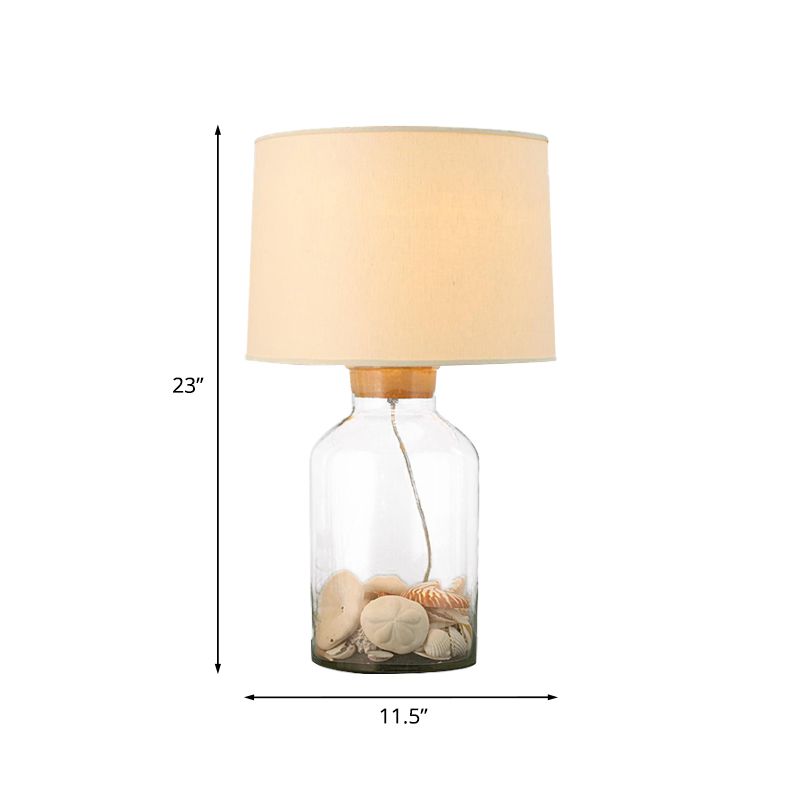White 1 Bulbo Night Mesa Light Lámpara de cañón tradicional de tela con base de vidrio transparente en forma de lata