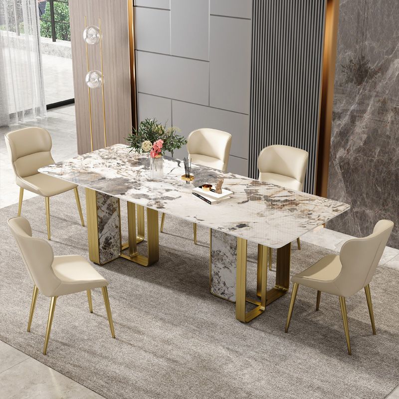 Mesa de comedor rectangular de piedra sinterizada de lujo con pedestal doble dorado