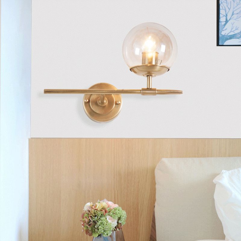 Brass Globe Wall Light Contemporary 1 Light Hand Blown Glass Sconce Light with Crossed Arm