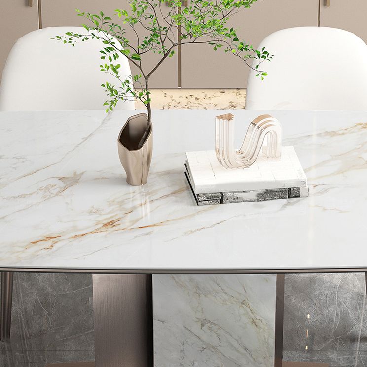Mesa de comedor de piedra sinterizada de lujo con pedestal de metal en oro rosa
