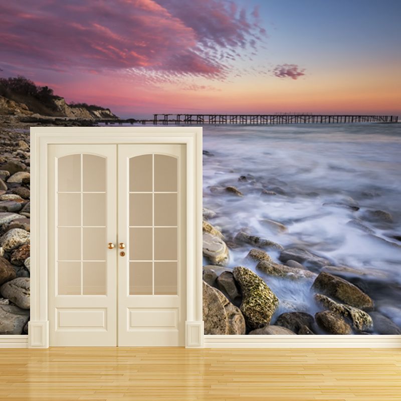 Pink-Blue Tropix Mural Full Size Rock Seashore with Distant Bridge at Dusk Wall Decor for Bedroom