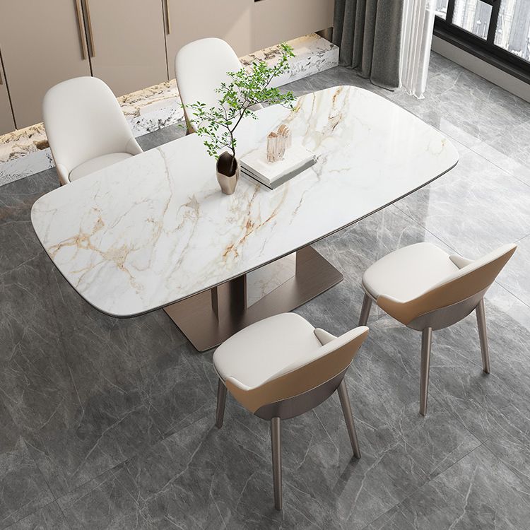 Mesa de comedor de piedra sinterizada de lujo con pedestal de metal en oro rosa