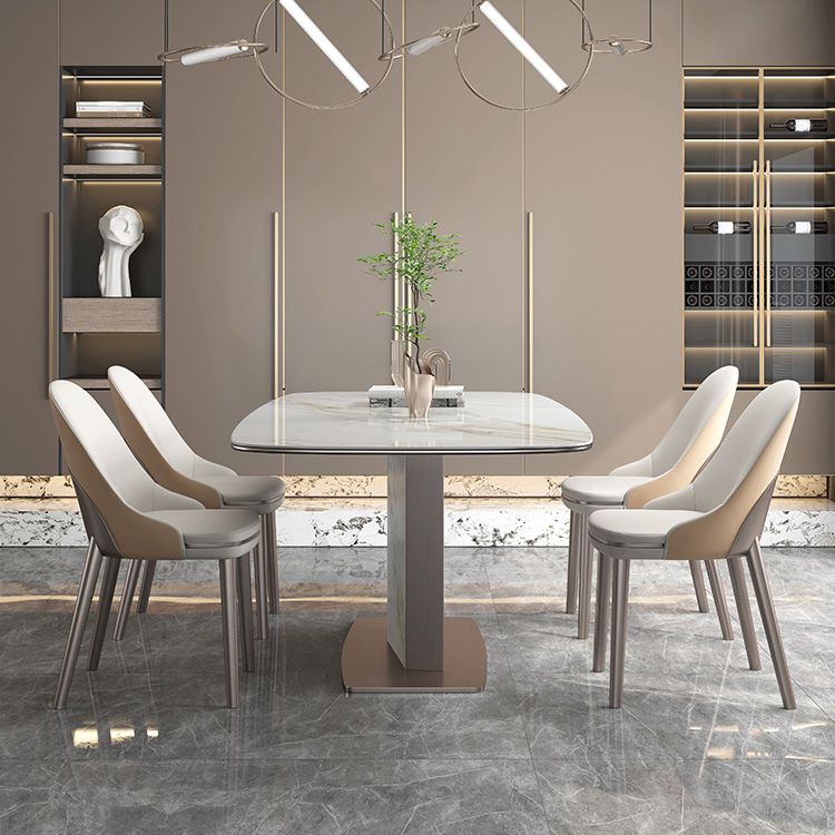 Mesa de comedor de piedra sinterizada de lujo con pedestal de metal en oro rosa