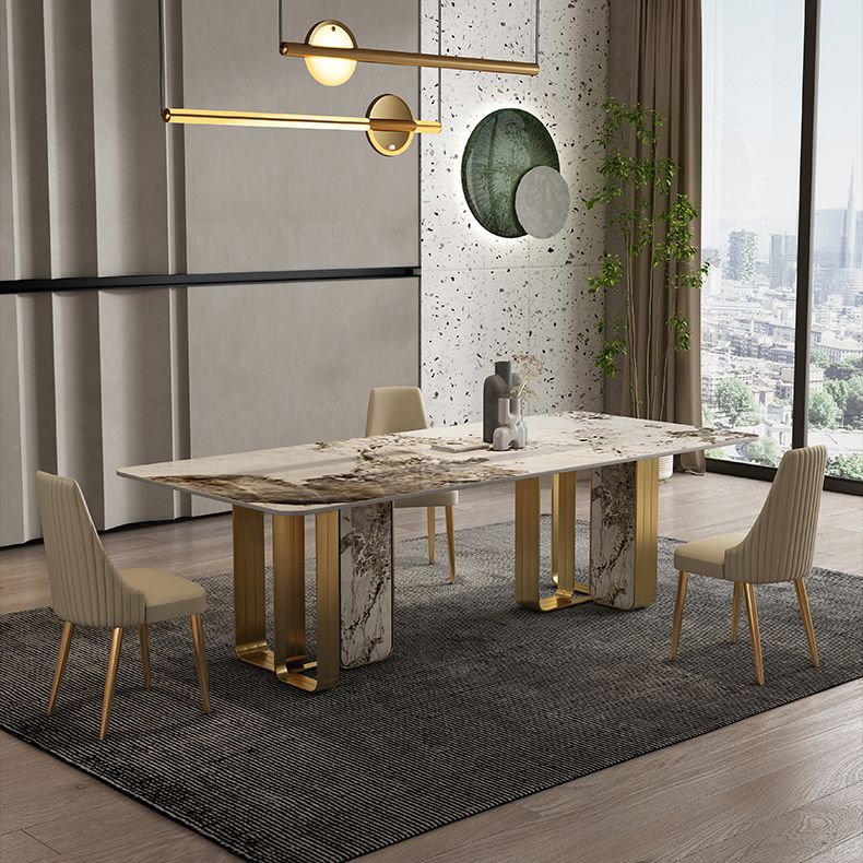 Mesa de comedor de piedra sinterizada de lujo con metal y piedra doble pedestal en oro