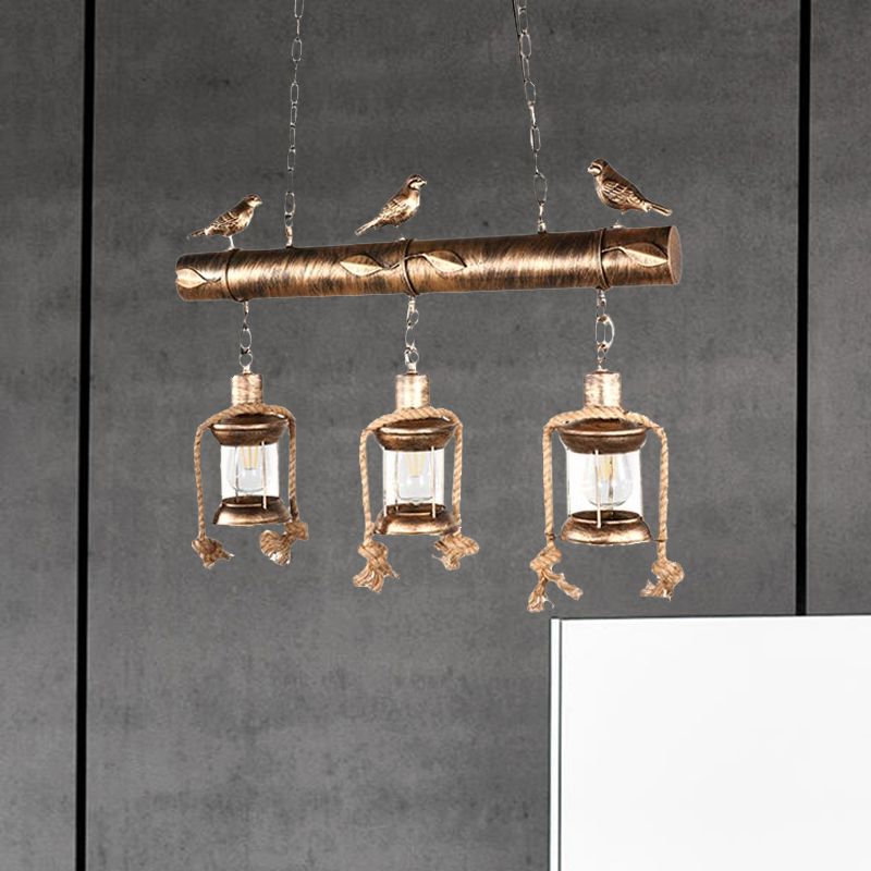 Coastal Lantern Island Pendant 3-Light Clear Glass Hanging Lamp Kit in Antique Brass with Bird