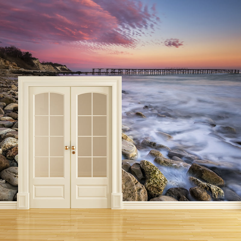 Pink-Blue Tropix Mural Full Size Rock Seashore with Distant Bridge at Dusk Wall Decor for Bedroom