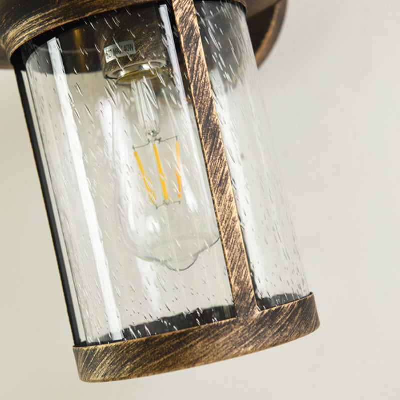 Cylinder Seeded Glass Wall Mounted Lamp Industrial Single Bulb Porch Sconce Light in Matte Black/Bronze with Cage