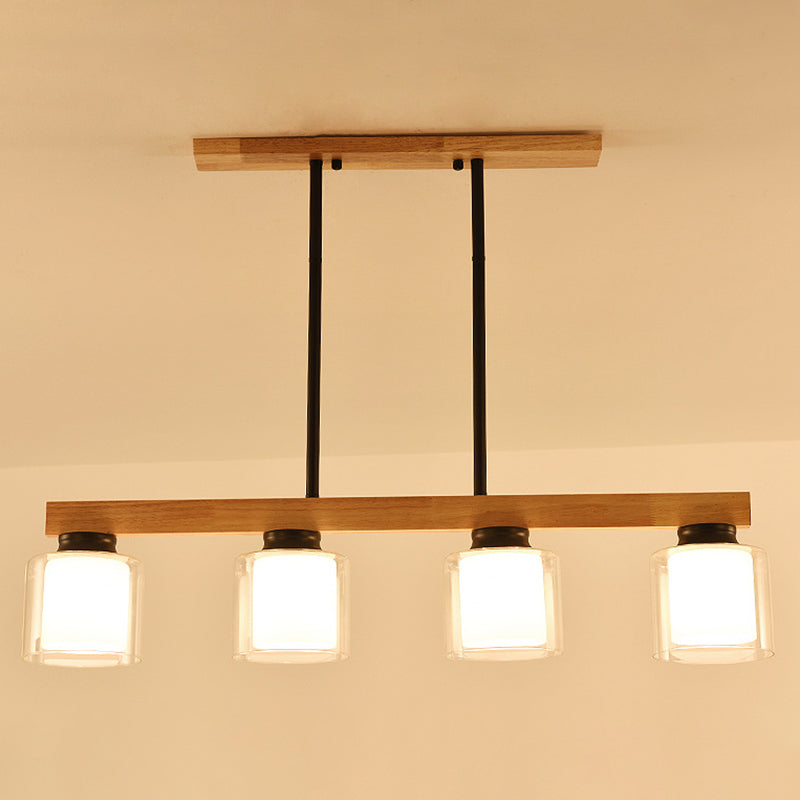 Ciondolo a isola moderna nordica con lampada da pranzo cilindrica in vetro del paralume.