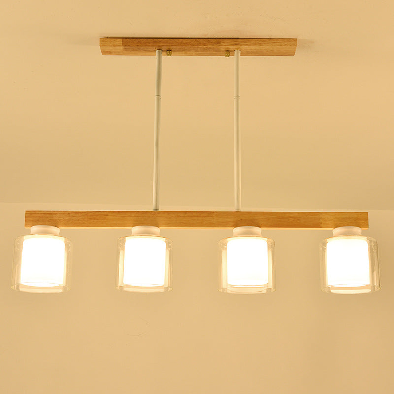 Ciondolo a isola moderna nordica con lampada da pranzo cilindrica in vetro del paralume.