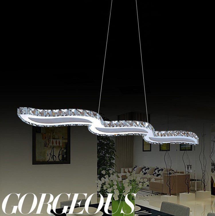 Moderno lussuoso lussuoso isola a pendente illuminazione ondata prismatica a soffitto di cristallo ottico per soggiorno