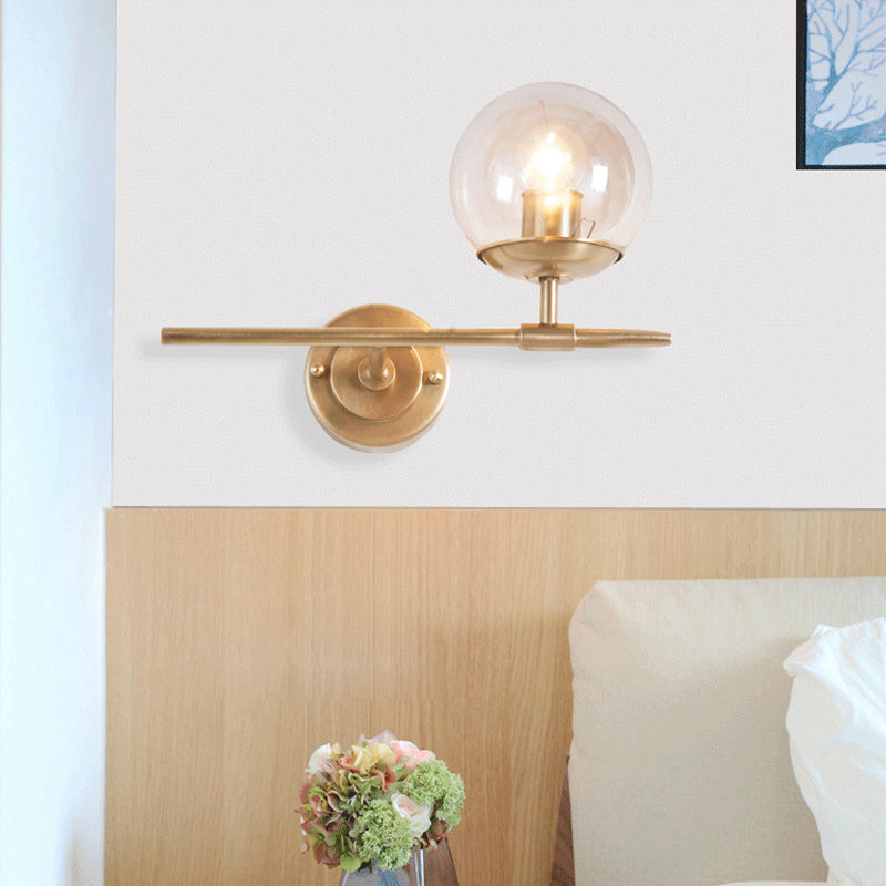 Brass Globe Wall Light Contemporary 1 Light Hand Blown Glass Sconce Light with Crossed Arm