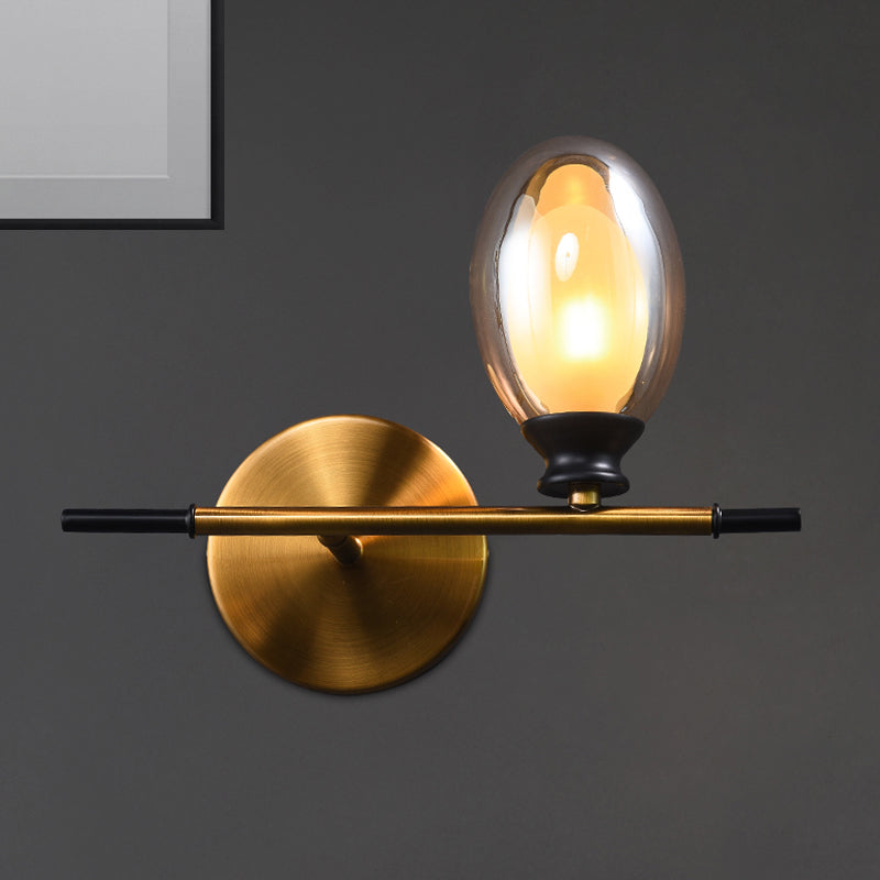 Clear/Amber Glass Egg Shape Wall Light Fixture Minimalist 1 Light Brass Sconce with Horizontal Arm