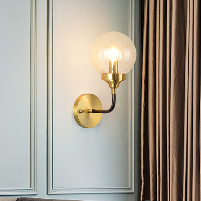 Simple Globe Wall Lighting Clear Glass 1 Bulb Sconce Light Fixture in Brass with Curved Arm