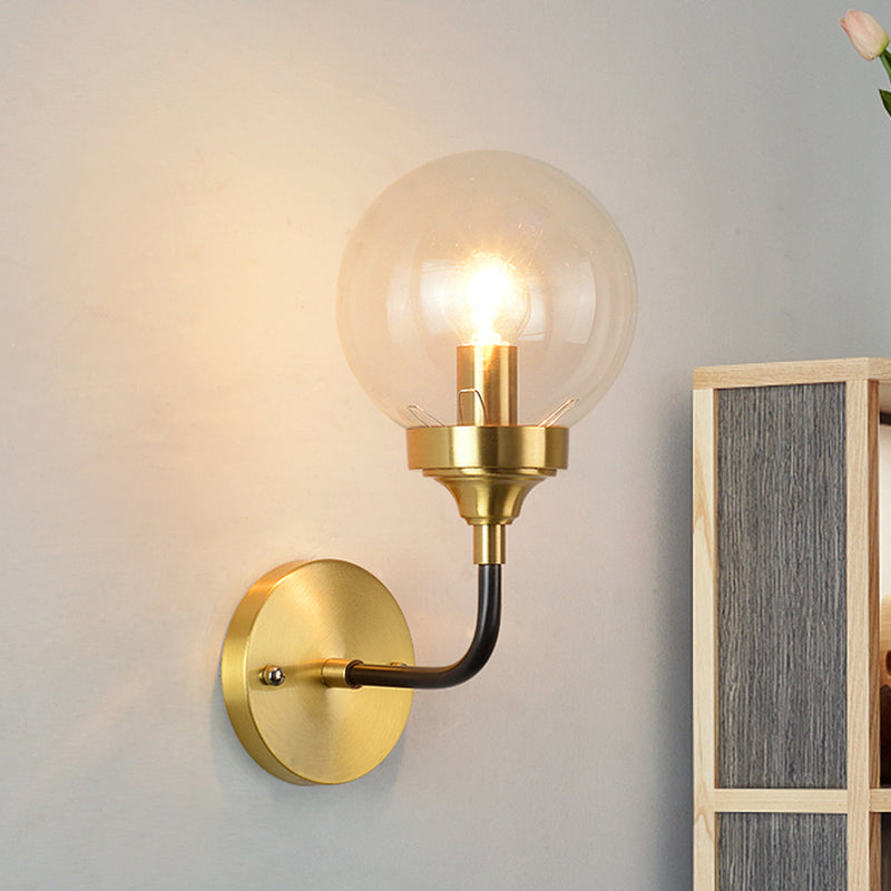 Simple Globe Wall Lighting Clear Glass 1 Bulb Sconce Light Fixture in Brass with Curved Arm