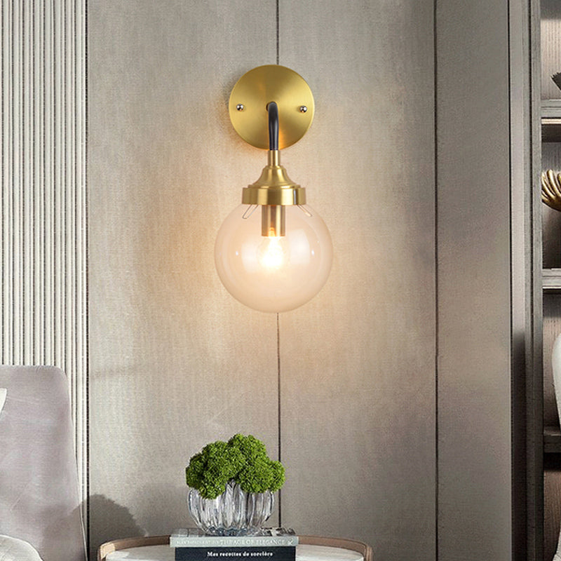 Simple Globe Wall Lighting Clear Glass 1 Bulb Sconce Light Fixture in Brass with Curved Arm