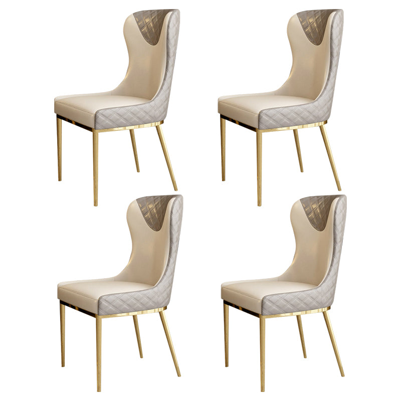 Silla sin brazos tapizada de cuero con respaldo lateral y patas de metal