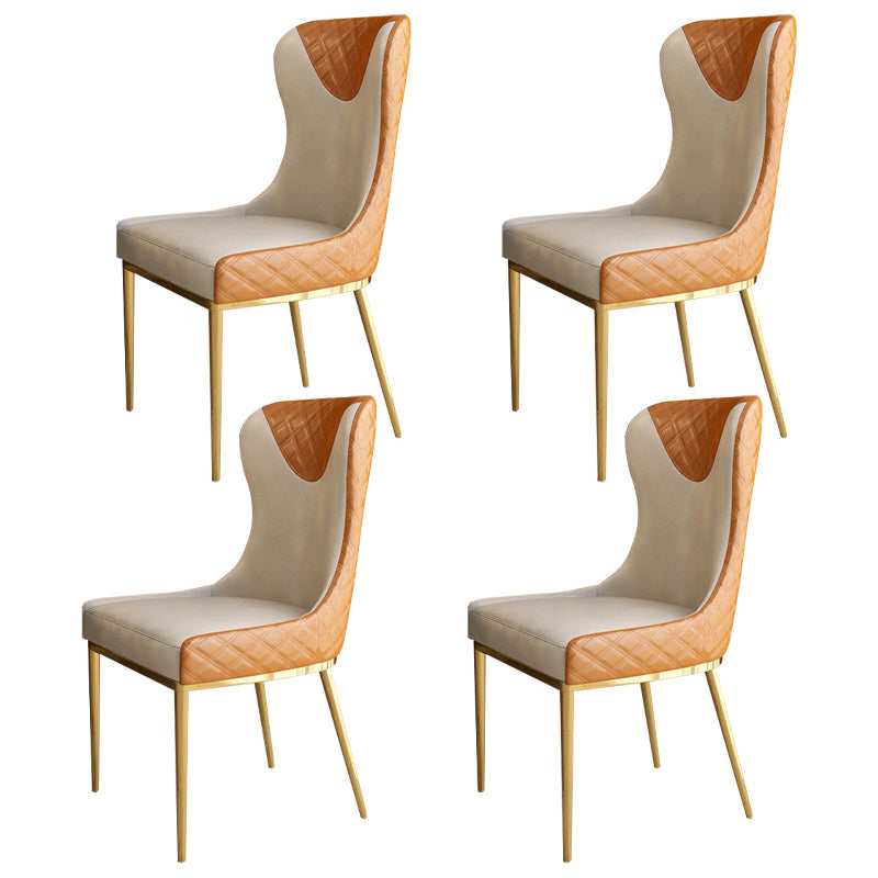 Silla sin brazos tapizada de cuero con respaldo lateral y patas de metal