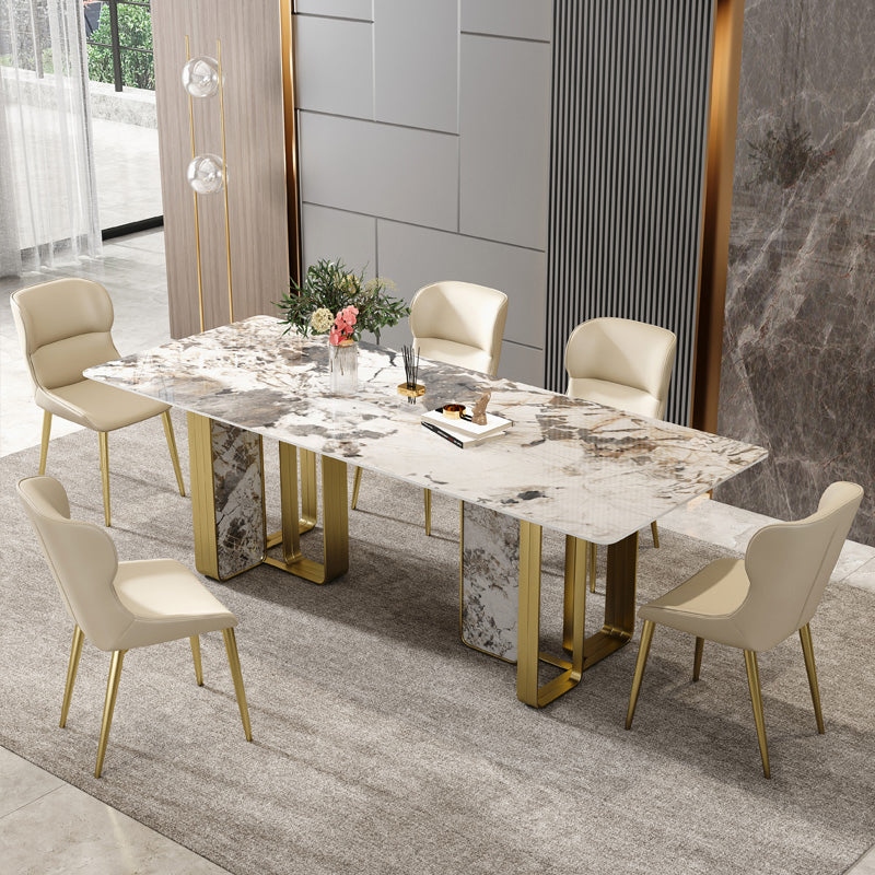 Mesa de comedor rectangular de piedra sinterizada de lujo con pedestal doble dorado