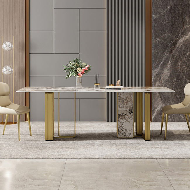 Mesa de comedor rectangular de piedra sinterizada de lujo con pedestal doble dorado