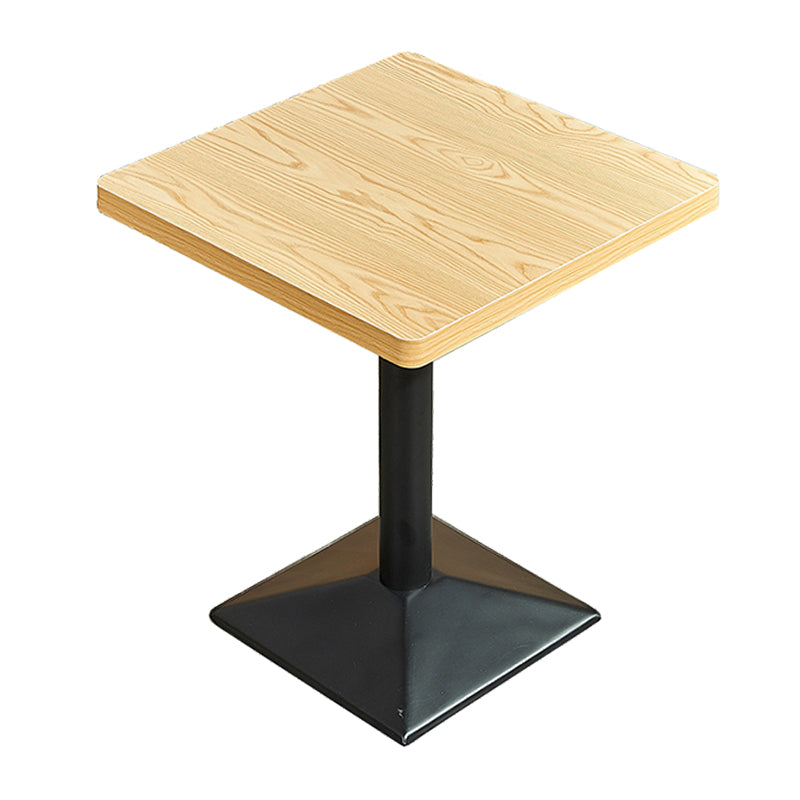 Mesa de comedor industrial de madera maciza con base de pedestal de metal