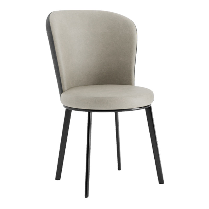 El lado contemporáneo del comedor preside la silla curvada de cuero mate de Parsons