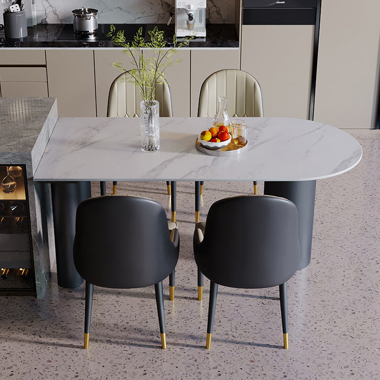 Tavolo da pranzo moderno con piano in pietra e base in acciaio nero