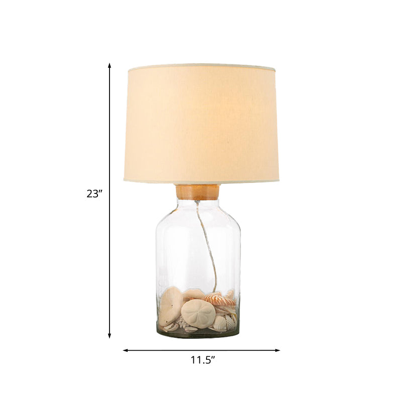 White 1 Bulbo Night Mesa Light Lámpara de cañón tradicional de tela con base de vidrio transparente en forma de lata