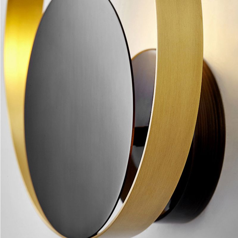Lampada a parete circolare nera e oro nella moderna semplicità della parete in ferro battuto per gli spazi interni