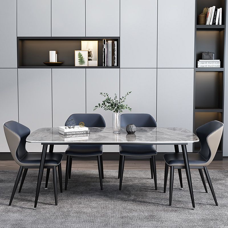 Juntos de comedor modernos con mesa de piedra sinterizada y sillas tapizadas