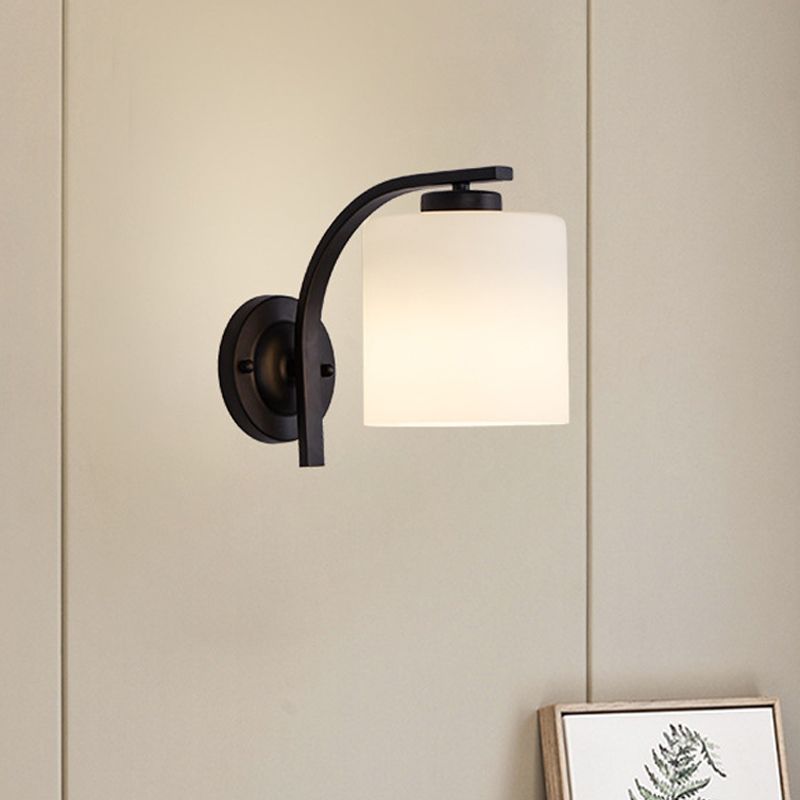 Black 1-Light Wall Sconce Simple Ivory Glass Cylinder Wall Mounted Lamp with Curved Arm