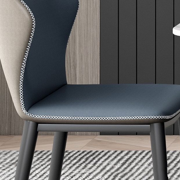 Silla lateral contemporánea con respaldo de orejas Silla sin brazos curvada de cuero con acabado mate