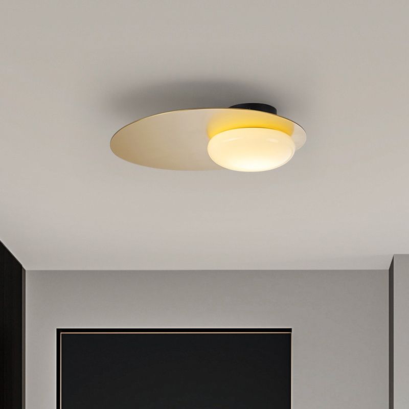 Cream Glass Ovoid Flush Mount Lamp Designer 1 Light Ceiling Lighting with Black / Brass Disk Top