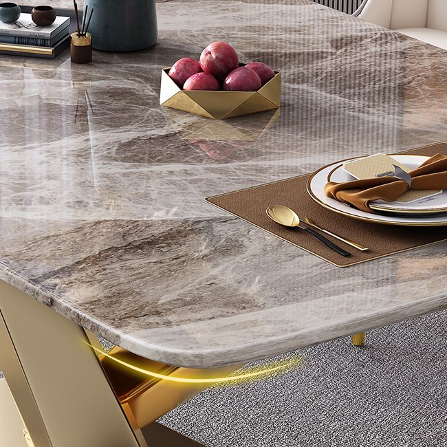 Mesa de comedor de piedra sinterizada de estilo moderno con mesa fija de altura estándar y base de caballete de oro