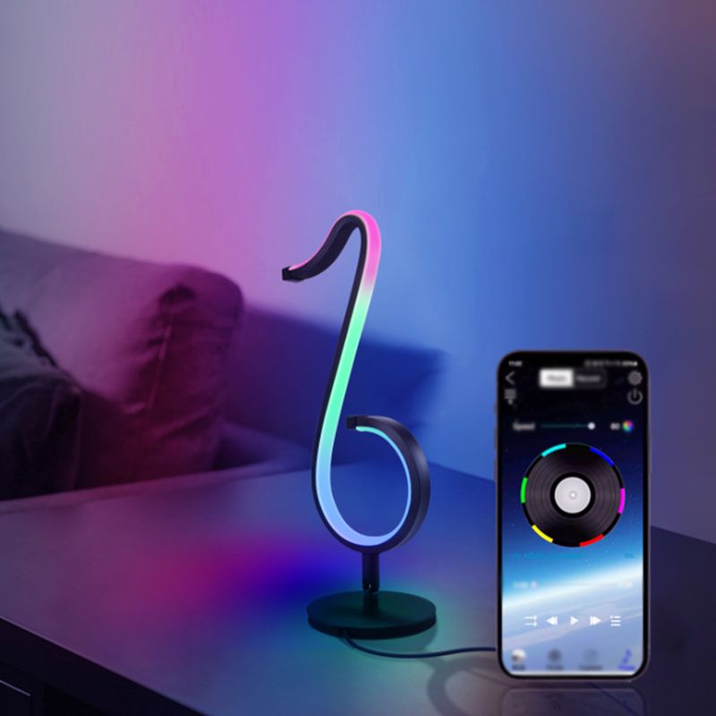 Lampada da tavolo a forma di nota musicale in metallo. Luce notturna a LED nera minimalista alla moda per camera da letto