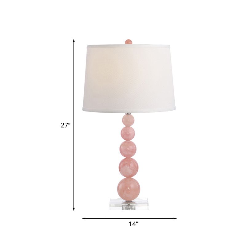 Lampada da comodino con paralume a botte Lampada da comodino bianca singola in tessuto modernista con supporto in vetro rosa con sfere