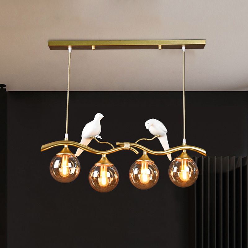 Sprig Island Pendant Light Postmodern Iron 4-Light Black/Gold Hanging Lamp with Amber Ball Glass Shade and Bird Deco