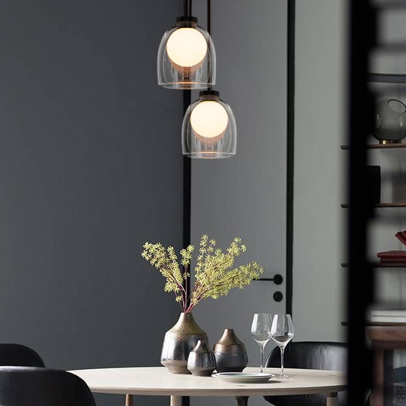 Lampe suspendue à la cloche en verre dans un pendentif en fer forgé moderne pour chambre à coucher