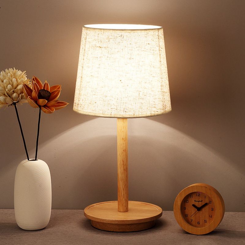 Lampada da comodino moderna affusolata in tessuto con 1 lampadina, colore bianco con base in legno