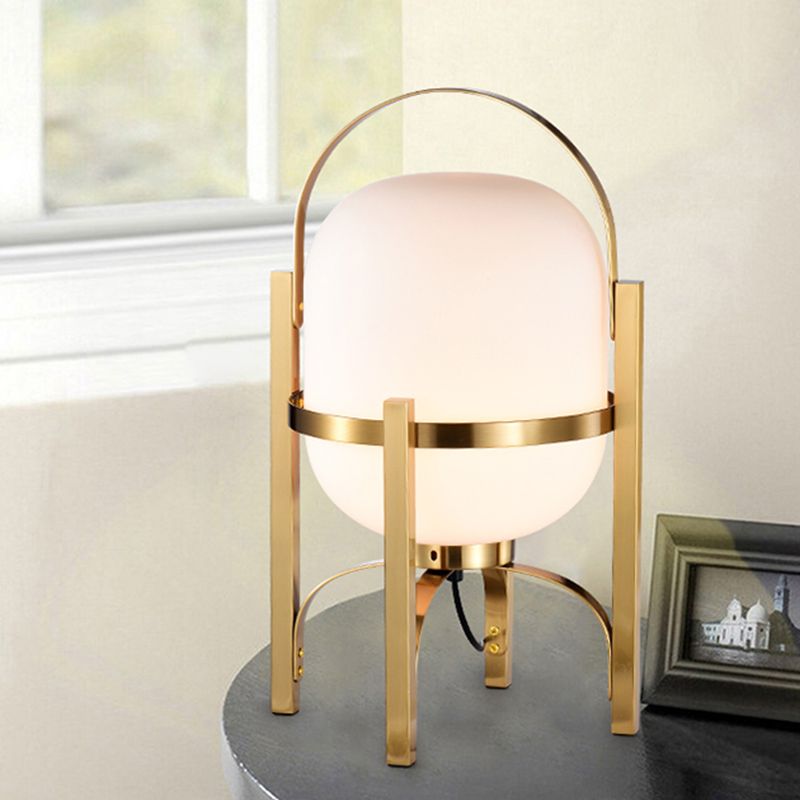 Lámpara de escritorio ovalada con acabado dorado y luz LED posmoderna para mesa de noche con pantalla de cristal blanco/gris humo