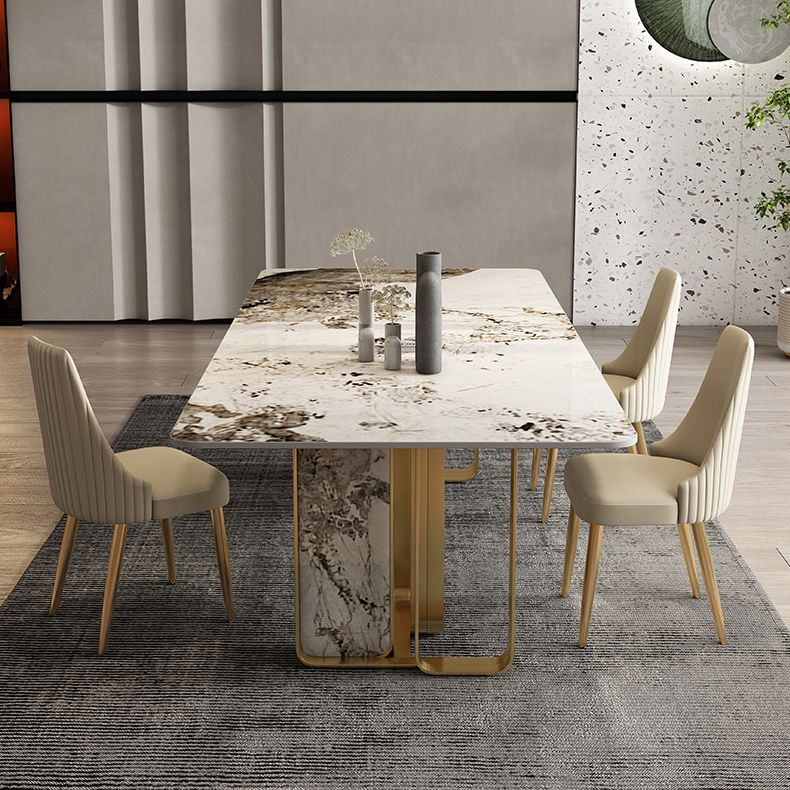 Mesa de comedor de piedra sinterizada de lujo con metal y piedra doble pedestal en oro