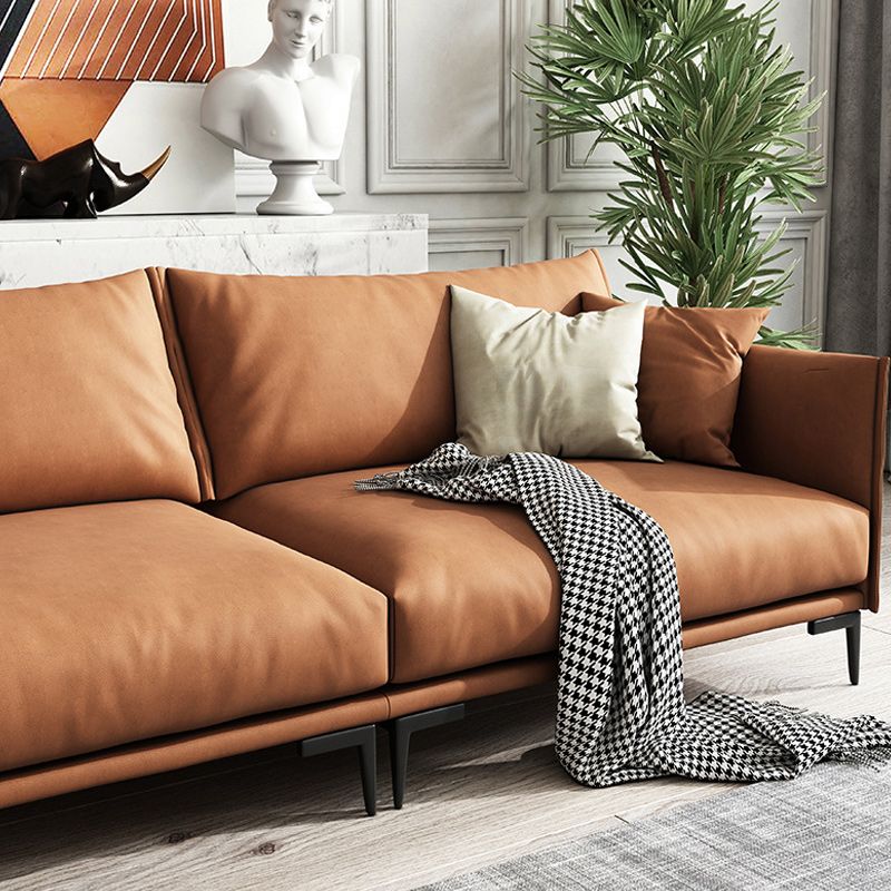 Salle de salon à armoine carré canapé orange standard avec coussins