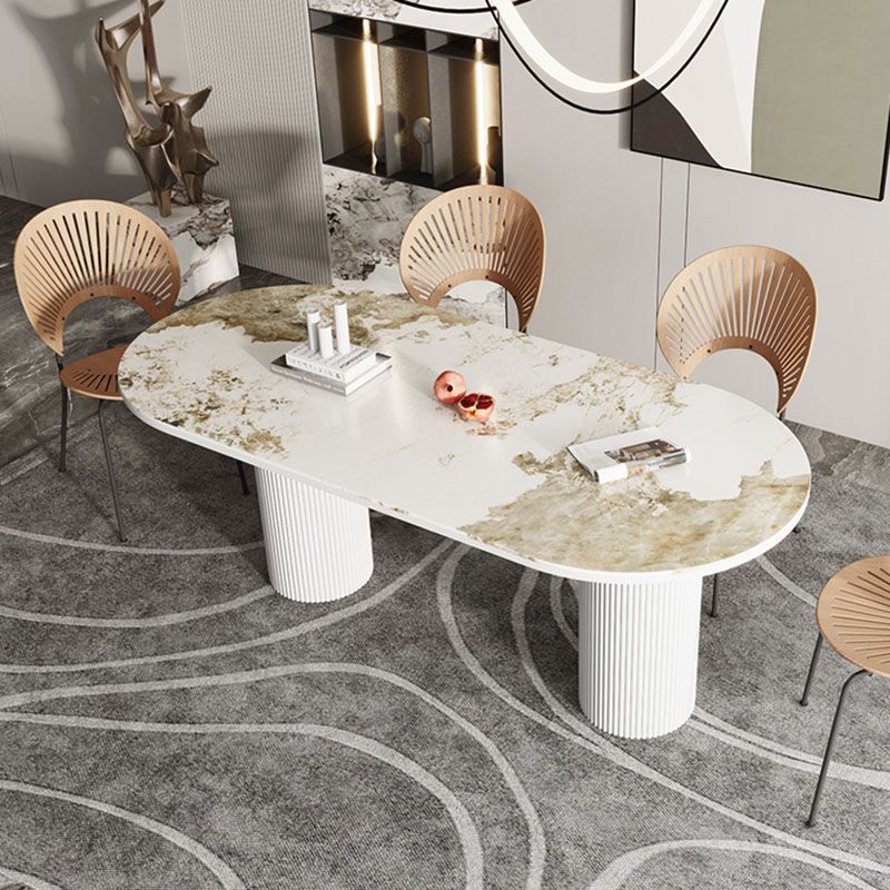 Table de salle à manger ovale moderne avec dessus en pierre et double piédestal en métal