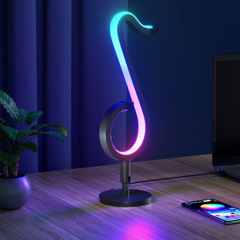 Lampada da tavolo a forma di nota musicale in metallo. Luce notturna a LED nera minimalista alla moda per camera da letto