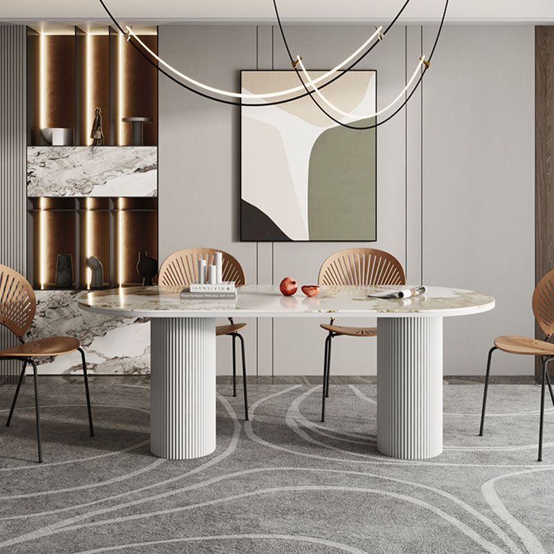 Table de salle à manger ovale moderne avec dessus en pierre et double piédestal en métal