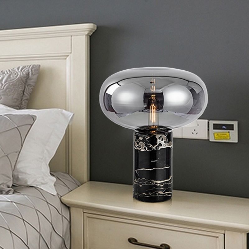 Lampada da tavolo da soggiorno ovale postmoderna in vetro grigio/ambra con 1 lampadina con base cilindrica in marmo nero